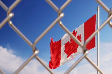 Fence In Front Of Canadian Flag
