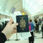 person holding Canada passport
