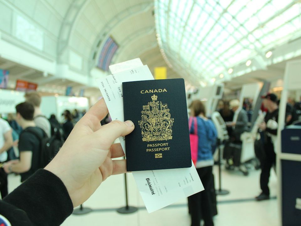 person holding Canada passport